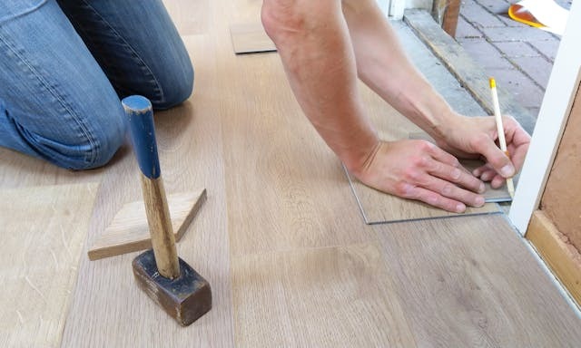 person replacing flooring