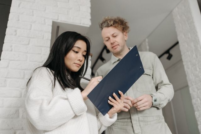 a person writing on a clipboard