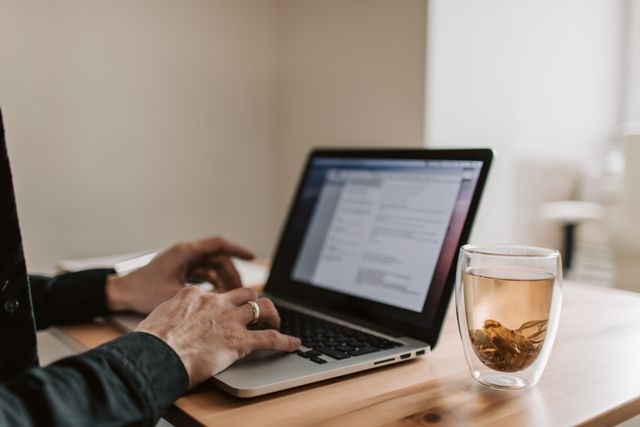 a person typing on a laptop