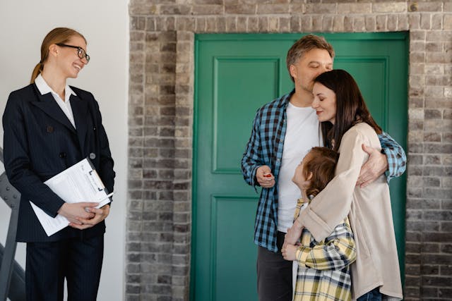 Three people hugging inside a home